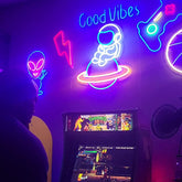 Astronaut Sitting on Planet Neon Sign